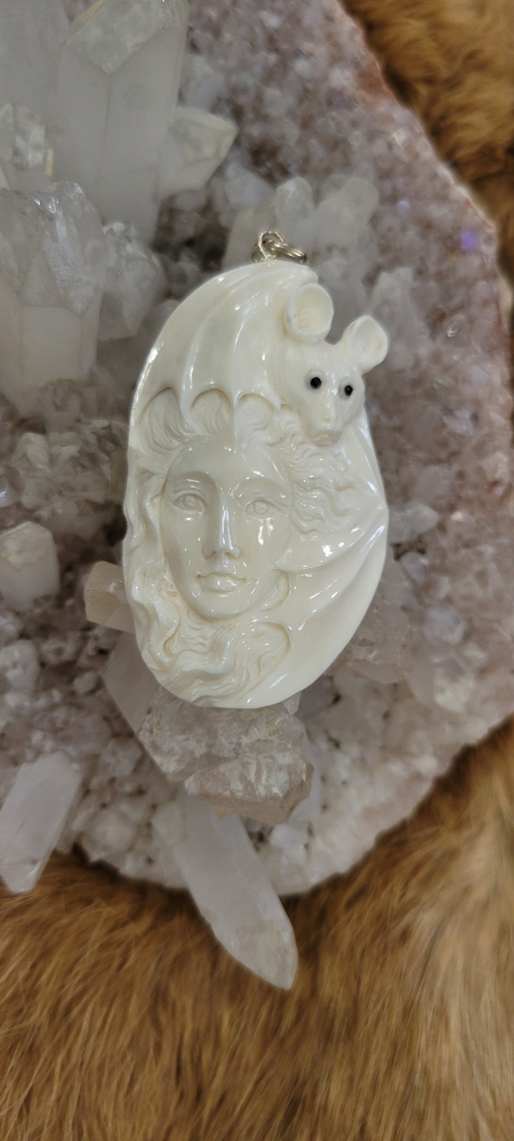 Bone carved bat and woman pendant